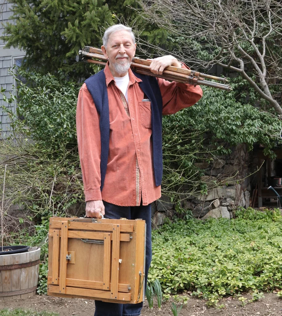 Richard Schmid standing with his painting gear he made himself.