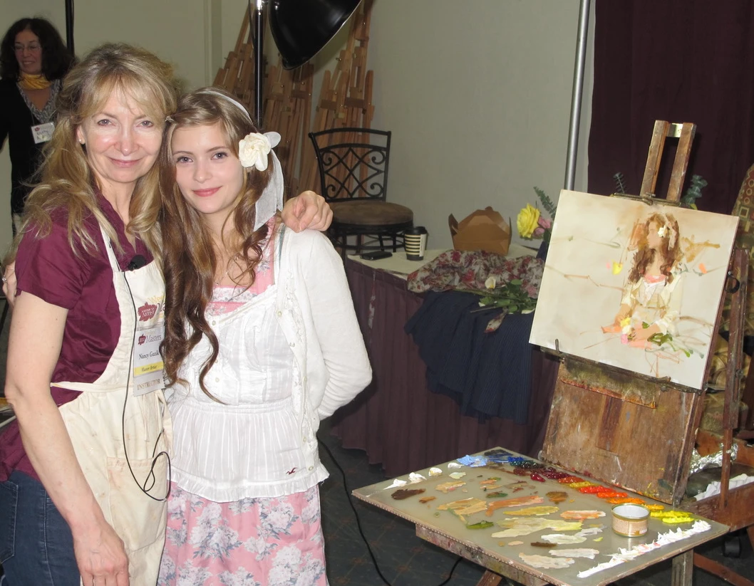 Nancy with her granddaughter during a portrait painting demo