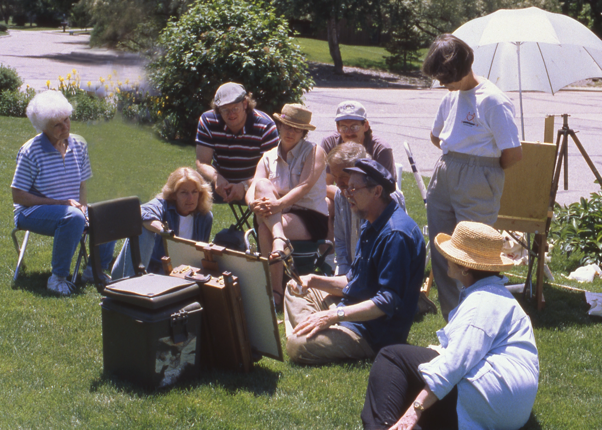 Richard demonstrating a painting outside with a group of students
