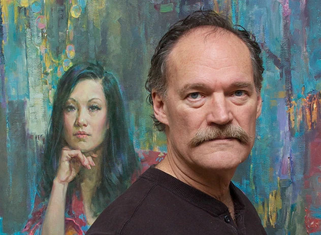 John Michael Carter standing in front of his painting
